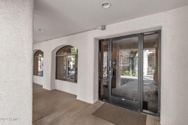 view of exterior entry featuring stucco siding