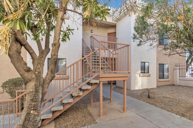 exterior space with stucco siding and a patio