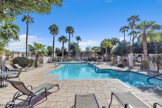 pool featuring a patio and fence