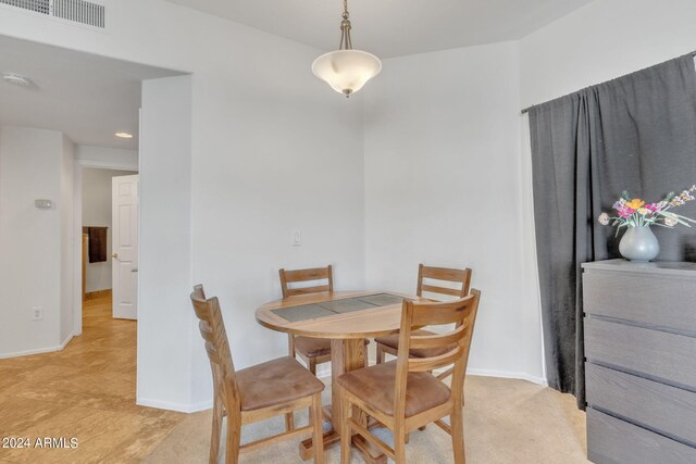 dining space featuring baseboards and visible vents