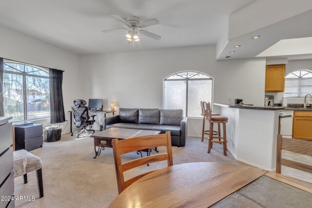 living room with recessed lighting, baseboards, light colored carpet, and a ceiling fan