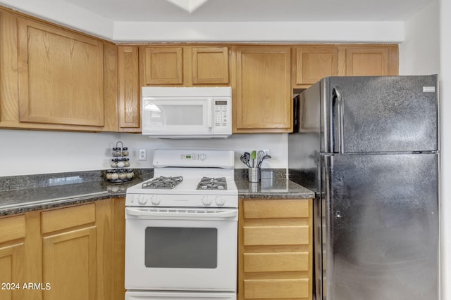 10030 W Indian School Rd Unit 218, Phoenix, AZ 85037 - kitchen featuring white appliances and dark stone counters