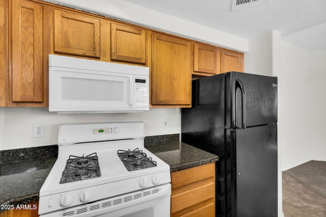 10030 W Indian School Rd Unit 218, Phoenix, AZ 85037 - kitchen with white appliances, brown cabinets, and dark stone counters