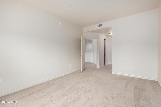 carpeted empty room with baseboards