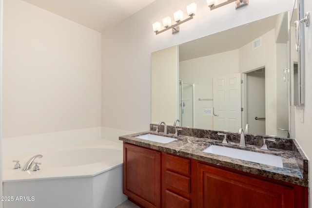 bathroom with a stall shower, a garden tub, and double vanity