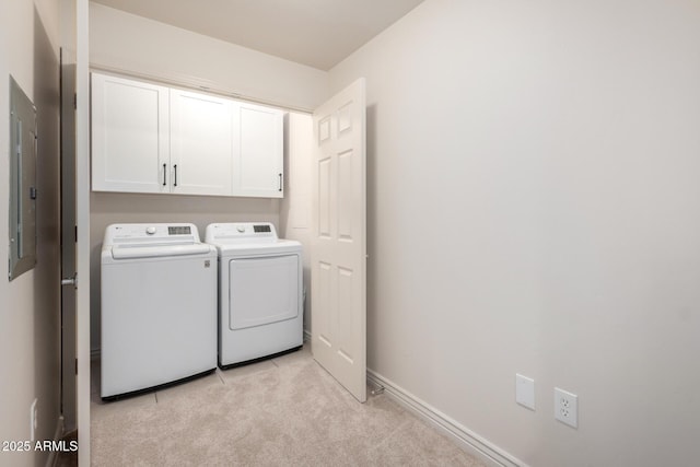 laundry area featuring cabinet space, washing machine and dryer, light carpet, and baseboards
