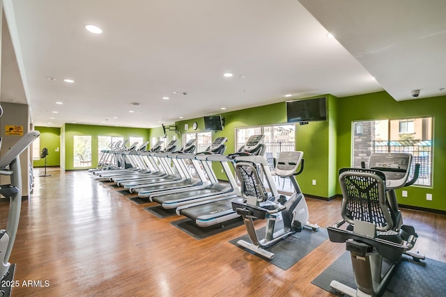 workout area with wood finished floors, recessed lighting, and baseboards