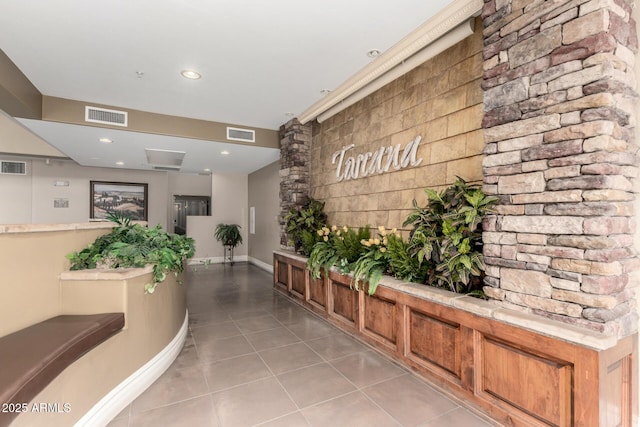 hall featuring light tile patterned floors, baseboards, and recessed lighting