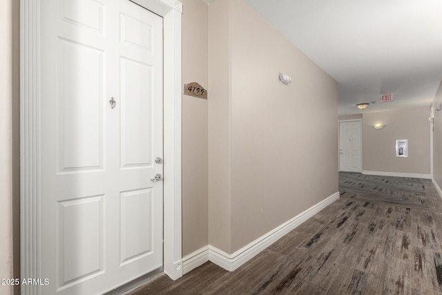hallway with wood finished floors and baseboards