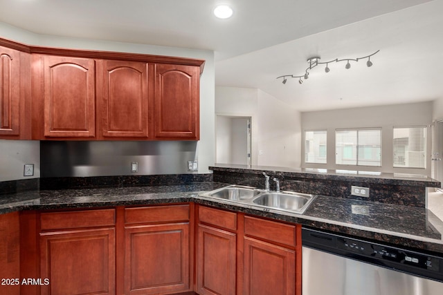 kitchen with dishwasher, a sink, and dark stone counters