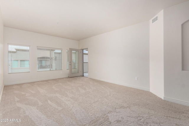 carpeted empty room with baseboards