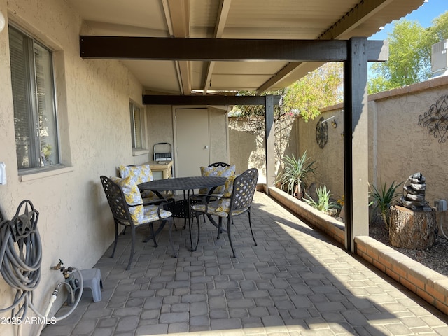 view of patio featuring outdoor dining area and a fenced backyard