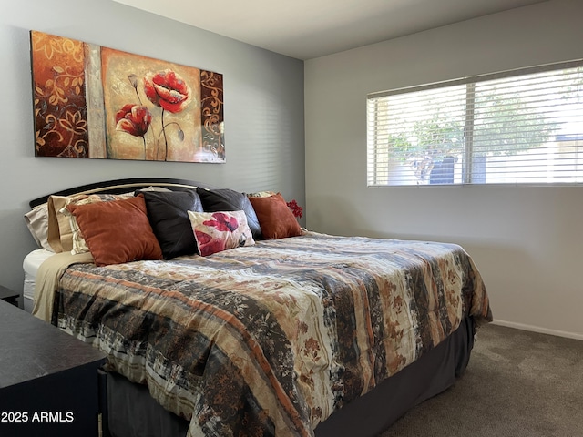 bedroom with baseboards and carpet