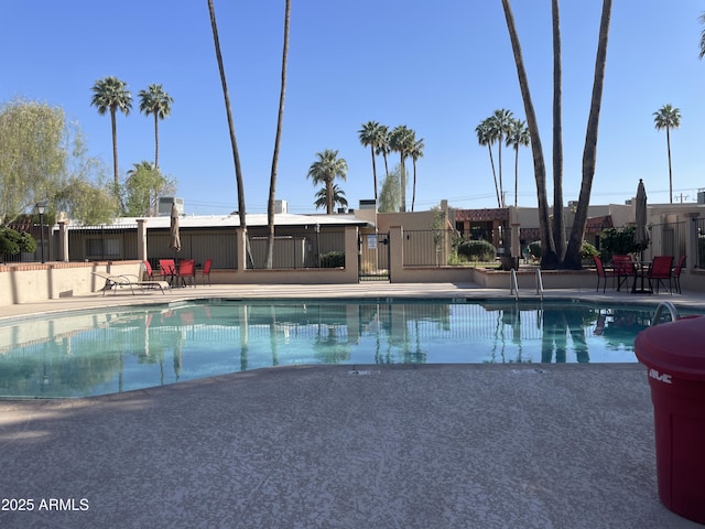 pool featuring a patio and fence