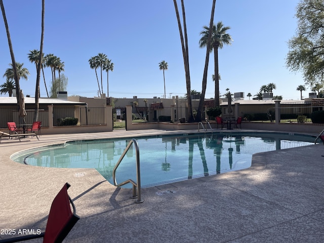 pool featuring a patio and fence