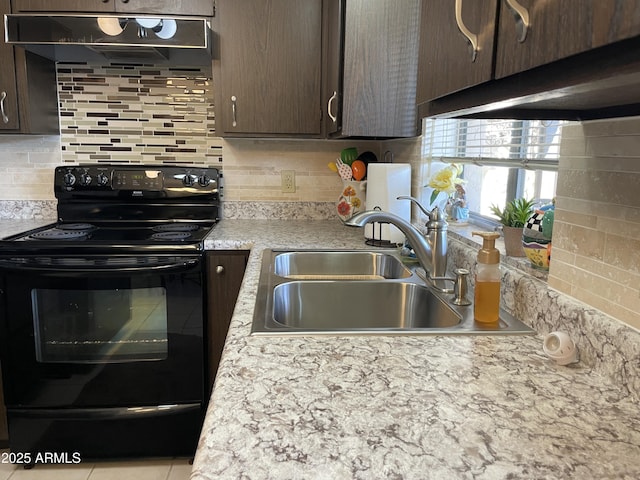 kitchen with light countertops, dark brown cabinets, under cabinet range hood, black range with electric stovetop, and a sink