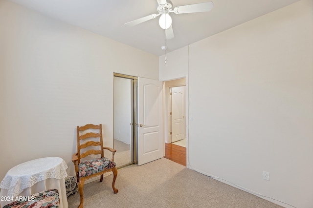 sitting room with light colored carpet and ceiling fan