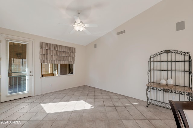 tiled empty room with ceiling fan and lofted ceiling