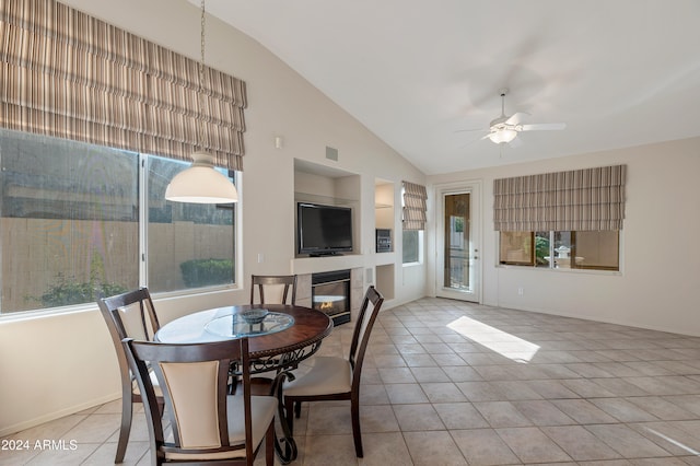 dining area with light tile patterned floors, vaulted ceiling, and ceiling fan