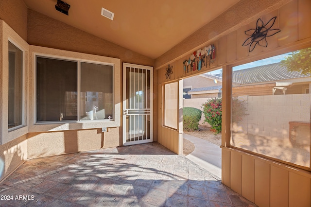 unfurnished sunroom with vaulted ceiling