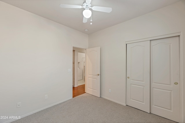 unfurnished bedroom with light carpet, a closet, and ceiling fan