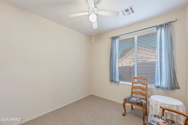 living area featuring carpet flooring and ceiling fan