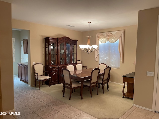 carpeted dining room with a notable chandelier