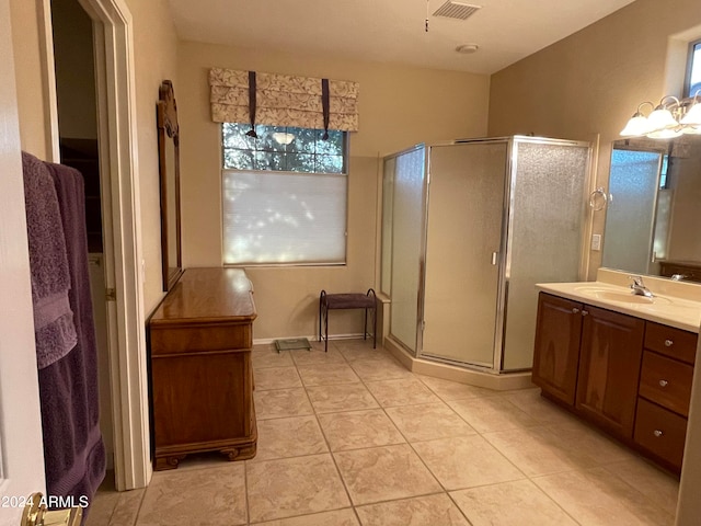 bathroom with vanity, a shower with shower door, and tile patterned floors