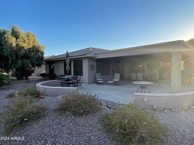 rear view of property featuring a patio area