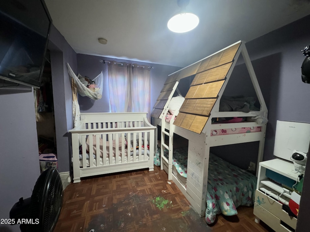 bedroom featuring dark parquet flooring