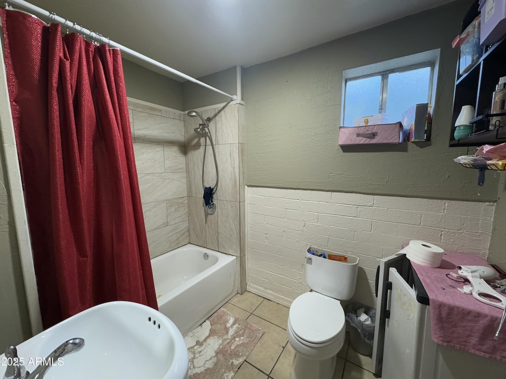 full bathroom with shower / bath combination with curtain, sink, toilet, and tile patterned flooring