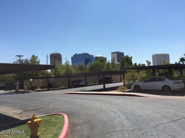 covered parking lot featuring a city view