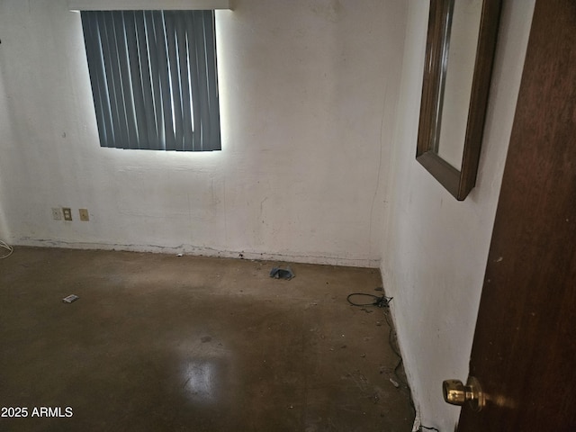 unfurnished room with concrete floors