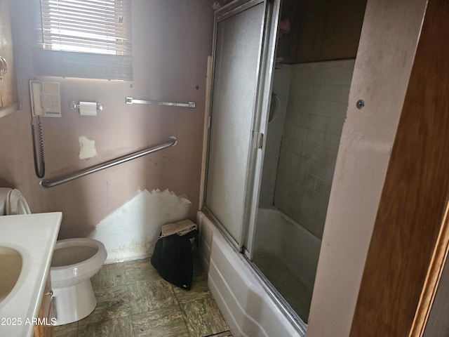 full bathroom with toilet, vanity, and shower / bath combination with glass door