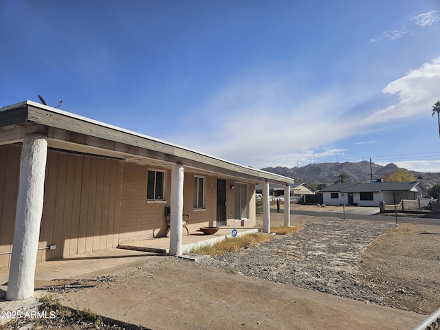 rear view of house featuring a mountain view