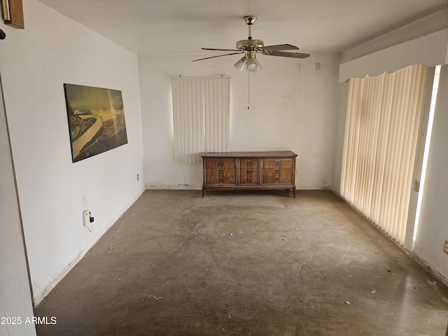 spare room featuring concrete floors and ceiling fan