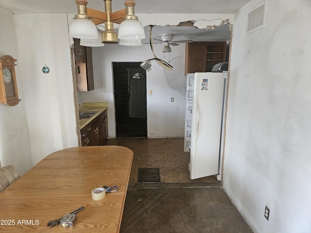 kitchen featuring sink, ceiling fan, and white fridge