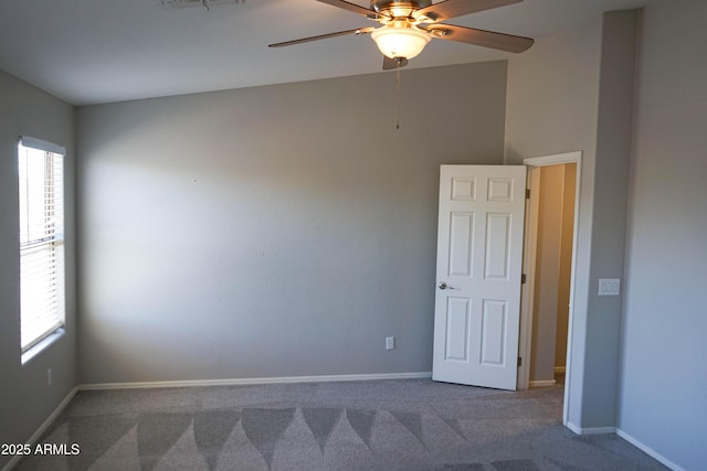 carpeted empty room featuring ceiling fan