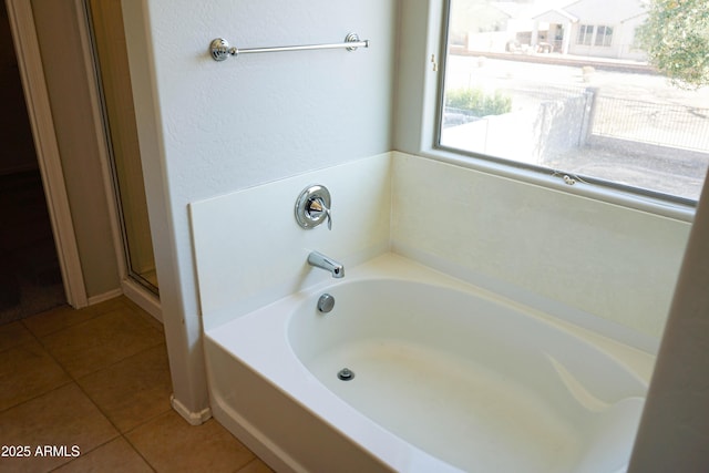 bathroom featuring tile patterned flooring and shower with separate bathtub