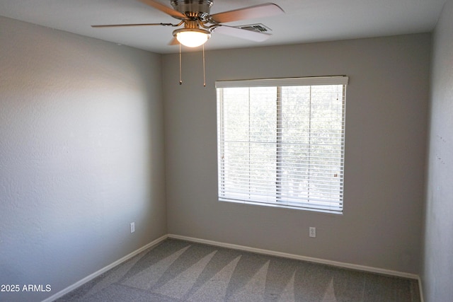 carpeted spare room with ceiling fan