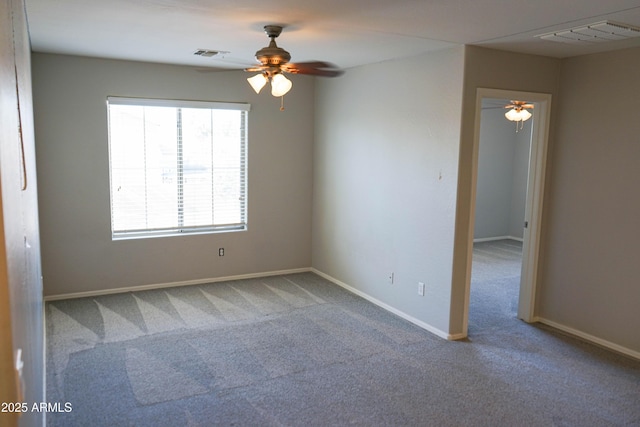 carpeted spare room with ceiling fan