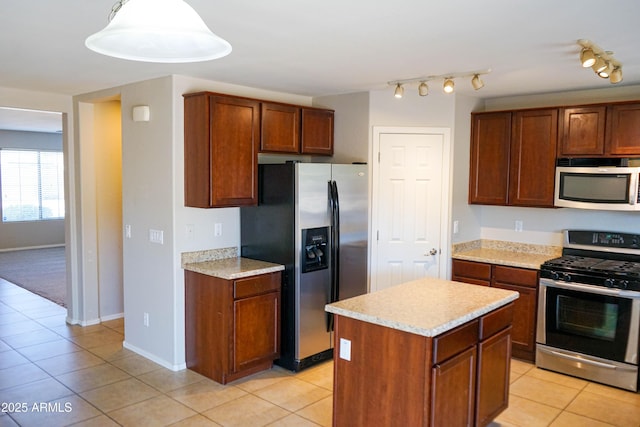 kitchen featuring appliances with stainless steel finishes, a center island, decorative light fixtures, and light tile patterned floors