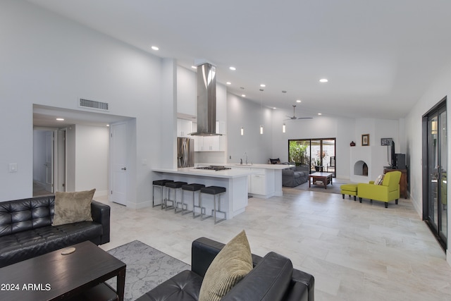 living room featuring a high ceiling and sink