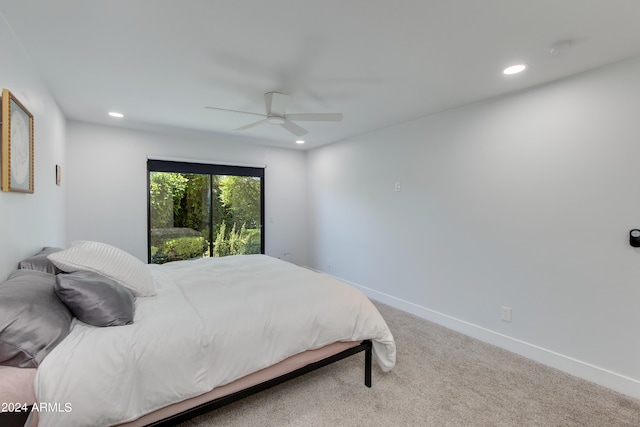 carpeted bedroom featuring access to exterior and ceiling fan