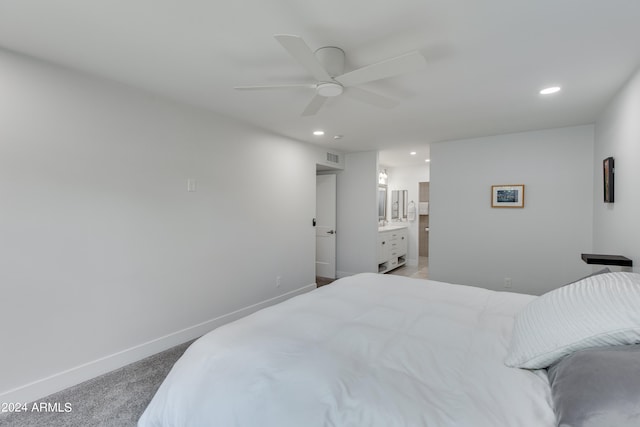 bedroom with ensuite bath, carpet floors, and ceiling fan