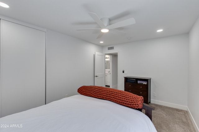 bedroom with carpet flooring, ceiling fan, a closet, and connected bathroom