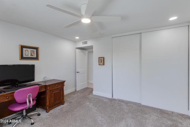 carpeted home office featuring ceiling fan