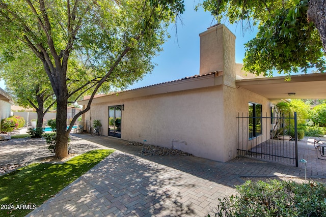 view of side of home featuring a patio area