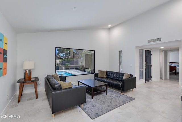 living room featuring high vaulted ceiling