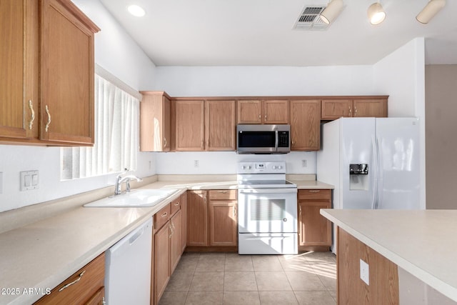 kitchen with sink, white appliances, and light tile patterned floors